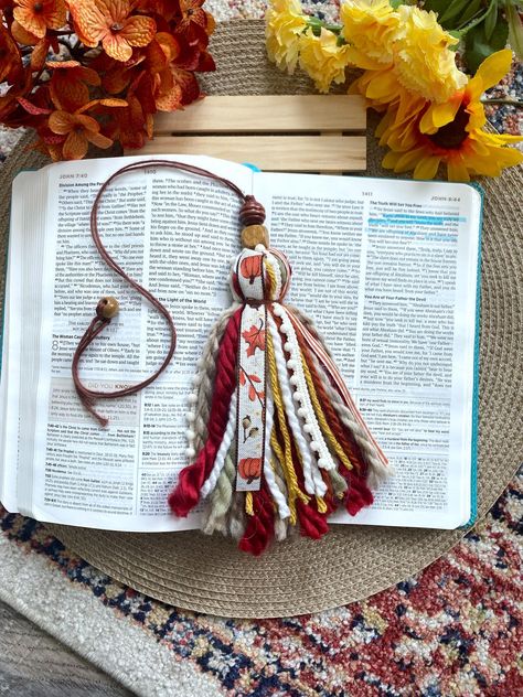 **Shipping** Shipping is 1-5 business days, although we try our best to ship ASAP! Autumn pumpkin Bible tassel! Details: * These Bible tassels hang on the side of your Bible(s). They make for a really cute and fun way to mark your place in the Bible. * The tassels have an extra long uncut cord to place in your Bible with a bead at the end to insure it fits many Bible sizes. Just simply cut the length to your liking, and then tie the bead on! Diy Bible Accessories, Bible Book Mark Ideas, Bible Personalization, Diy Bible Tassels, Bible Tassel Bookmark Diy, Bible Decorating, Bible Tassel, Keychain Crafts, Bible Decor