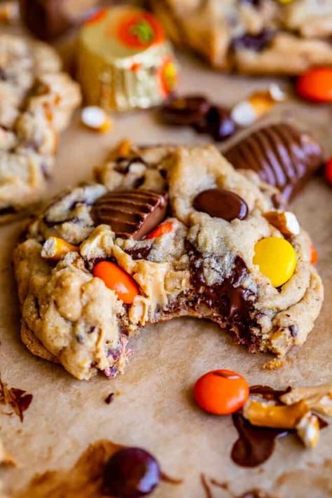 Outrageous Pretzel Reese's Peanut Butter Cookies from The Food Charlatan. These decadent cookies are soft, chewy, and irresistible! A peanut butter cookie dough packed with chopped pretzels, Reese's cups, Reese's Pieces, peanut butter chips, dark chocolate chips, and optional peanuts make these the peanut butter cookies of your dreams! The pretzels do not get soggy in the dough, they maintain their snap and crunch even after chilling or freezing the dough. These are great to make with kids! Peanut Butter Cup Pretzel Cookies, Peanut Butter And Hershey Kiss Cookies, Cookies Using Pretzels, Crumble Reeses Peanut Butter Cookies, Reeses Baking Cups And Pieces Recipes, Peanut Butter Reeses Pieces Cookies, Stuffed Reeses Cookies, Reese Pieces Peanut Butter Cookies, Peanut Butter Cookies Halloween