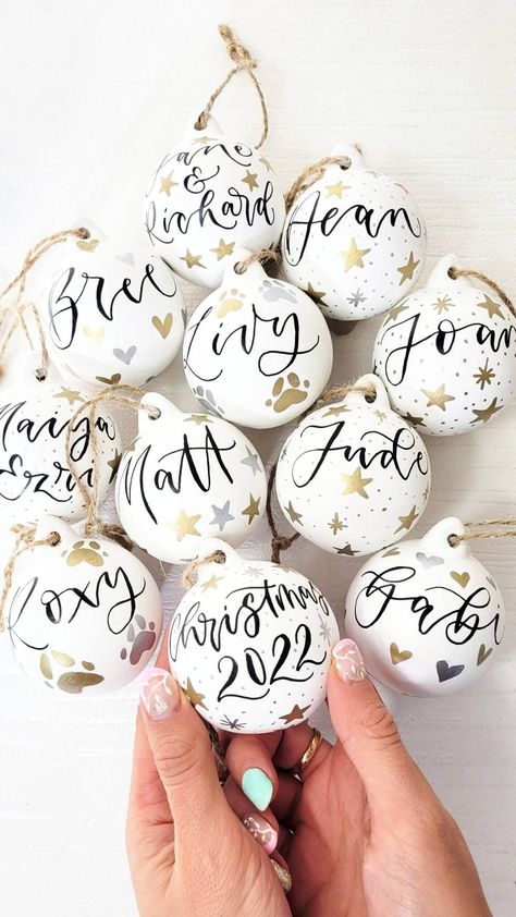 The perfect stocking filler or decoration for your tree. These white ceramic baubles are painted white, personalised with hand-lettered calligraphy and tied with brown twine ready to display proudly on your Christmas tree. The calligraphy baubles make the perfect keepsake and can be personalised with the wording of your choice.  These baubles are a perfect secret santa gift or for marking a milestone such as a first christmas, new home or engagement or getting married.  What can I have on my bau Personalised Ceramic Baubles, Hand Painted Ceramic Baubles, Painted Ceramic Baubles, Bauble Designs, Hand Painted Baubles, Personalised Baubles, First Christmas New Home, Folk Christmas, Christmas Table Decorations Centerpiece