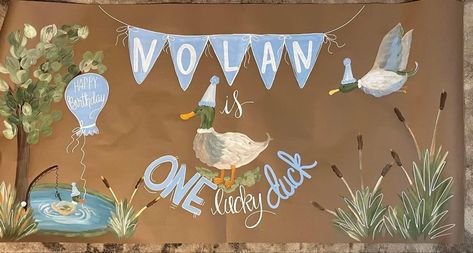 Little boys first birthday duck theme banner Duck Hunter First Birthday, One Lucky Duck Backdrop, Mallard Birthday Theme, One Lucky Duck Photoshoot, One Lucky Duck Birthday Theme, Duck 1st Birthday Boy, Mallard Birthday Party, One Lucky Duck Cake, One Lucky Duck Birthday Party Decor