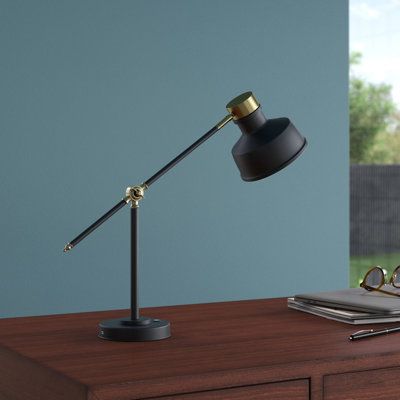 This 18" tall desk lamp features an adjustable counterbalance arm that lets you position it at just the right angle as you read or complete day-to-day tasks. It's crafted from aluminum in a sleek black tone for a modern industrial look, and it has a round base and a central rod that meets the arm and a matching metal shade. This shade directs light from an included LED bulb. We love the antique gold brass-finished accents that add a glam touch to the overall design. A convenient touch switch is Tall Desk, Industrial Desk Lamp, Metal Desk, Industrial Desk, Fixture Table, Metal Desks, Touch Switch, Adjustable Desk, Gold Brass