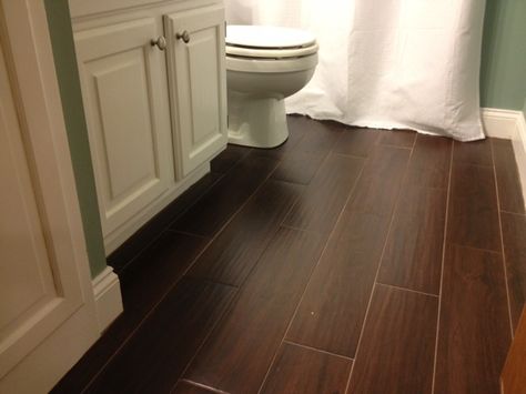 Like the wood looking tile, especially for the laundry room Dark Wooden Floor Bathroom, Bathroom Dark Brown Floor, Bathrooms With Dark Wood Floors, Dark Wood Floor Bathroom Ideas, Dark Wood Floor Bathroom, Dark Wood Bathroom Floor, Dark Engineered Wood Floors, Bathroom Dark Floor, Dark Vanity Bathroom