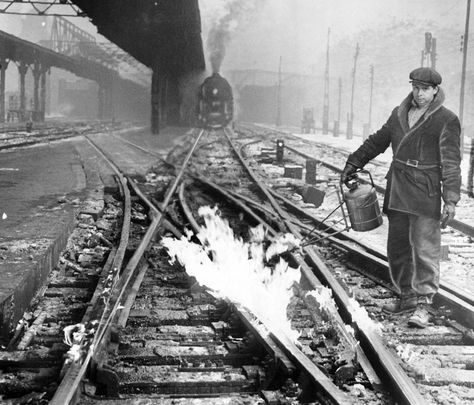 Arthur LaCaille uses a gasoline torch to light gas jets which thaw out switches in the rail yard outside LaSalle Street Station in Chicago on Dec. 26, 1944. Chicago December, Gandy Dancer, Road Workers, General Strike, Chicago Pictures, Vintage Railroad, Railroad Pictures, Railroad Photography, Old Trains