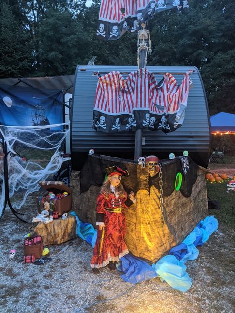 Halloween campsite decoration. Pirate ship trailer Halloween Ideas For Campsites, Camper Pirate Ship, Trailer Halloween Decor, Pirate Camper Decorations, Pirate Themed Campsite, Halloween Decorated Campsites, Halloween Trailer Decorations, Halloween Decorations For Camper, Trailer Halloween Decorations