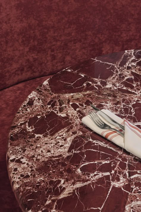 This restaurant table top is made from a deep-red-toned marble with cream coloured streaks. Tulum Design, Maximalism Aesthetic, Make Up Salon, Plan Studio, Layered Architecture, Middle Eastern Restaurant, Index Design, Color Streaks, Red Marble