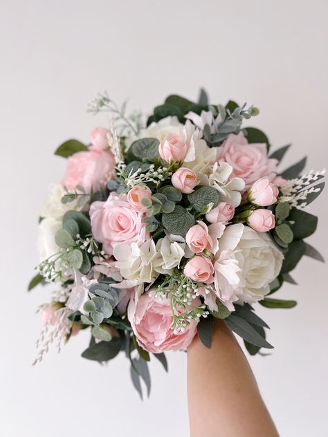 "White bridal wedding bouquet is created with high quality silk flowers. These handmade artificial wedding bouquets make beautiful additions to wedding and event floral arrangements. Flowers: peonies, roses, eucalyptus and fillers. Colors: white, pink, pale pink, blush pink, pale champagne, green. Handle: wrapped in ivory satin ribbon. Size: bridal bouquet is approximately 14\" wide, bridesmaids bouquet is 8\". SUGGESTION: steaming the bouquets, boutonnieres, corsages upon receiving them and you Wedding Bouquets Bride White And Pink, Pink White Champagne Wedding, Blush Pink Wedding Flowers Bride Bouquets Peonies, Pale Pink Bridal Bouquet, Wedding Sage Green And Pink, Pink Floral Bouquets, Wedding Bouquets Pink And Green, June Wedding Flowers Bridal Bouquets, Light Pink And Sage Green Wedding