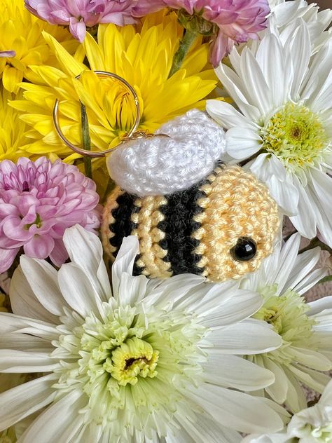 🐝 Bring a touch of whimsy to your daily essentials with this adorable crochet bee keychain!  🍯 This little bee makes a thoughtful and heartwarming present for birthdays, holidays, or the random Tuesday! Treat yourself or surprise a friend with this adorable accessory! Crochet Bee Keychain, Bee Keychain, Bee Free, Handmade Plushies, Crochet Bee, Keychain Cute, Adorable Crochet, Bee Design, Sweet Gifts