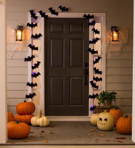 A bat colony at your front door? Hang our Light-Up Bat Colony String Lights and greet friends and neighbors with a batty smile! Cluster the two 10’L strands together to resemble a bat colony, or arrange in any way you like. (Sure, we know bats don’t really exude a purple glow…but that just adds to the spooky fun factor!) These lights can be used inside or in a covered area outdoors. A simple way to add some fun décor to your Halloween decorations! 2 AA batteri Entrada Halloween, Porche Halloween, Halloween Decorations Outdoor Porch, Porch Lights, Halloween Decor Diy, Halloween Front Doors, Halloween Decorations Outdoor, Casa Halloween, Halloween Front Porch Decor