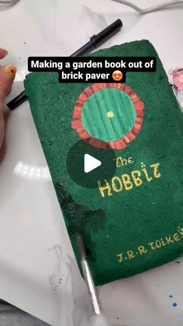 Welcome to the world of books! 🌹 on Instagram: "By @melanimichelleart : Making a garden book out of brick paver 😍 #mybookgramm #booksbrat  : : : : : : : #bookart #bookalcoholic #bookaddicted #booksbooks #bookarts #bookartist #vscoreads #vscobooks #booksonbooks #ilovetoread #readingismagic #booksarelove #readingismyhappyplace #readingisfun #readingismagic #fortheloveofbooks #library #libraries #fortheloveofbooks #bookbloggersofinstagram #bookcollector #beautifulbooks #beautifulbook" Hobbit Book, Garden Pavers, Yard Inspiration, Brick Art, Brick Garden, Bricks Diy, Brick Pavers, Big Garden, Handy Dandy