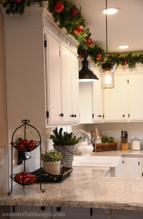 Festive Kitchen Decor, House Decorating Christmas, Christmas Above Cabinets Decor Kitchen, Upper Cabinets Christmas Decor, Christmas Decoration Inside House, Christmas Decor Idea For Kitchen, Christmas Garland Over Kitchen Cabinets, On Top Of Cabinet Christmas Decor, Front Yard Xmas Decorations