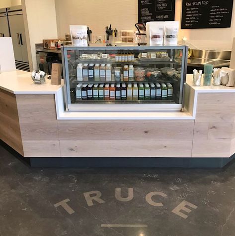 For Truce Juice in Minneapolis, we cut their logo out of a "paint mask" vinyl material and applied it to their concrete floor. Then they stained the floor and removed the vinyl leaving a logo imprint. Restaurant Concrete Floor, Bakery Design Interior, Painted Concrete Floors, Vinyl Store, Concrete Stained Floors, Painted Floor, Business Signage, Bakery Design, Concrete Floor