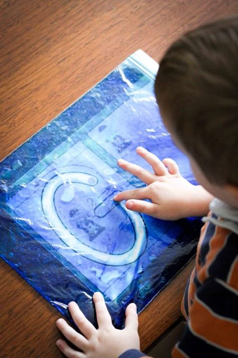 Sensory gel writing. Fill a snap-lock bag with a bit of hair gel and some food coloring and mix together. Such a fun way to get your kiddos to write! Sensory Ziplock Bags Hair Gel, Sensory Tracing, Preschool Letter G, Letter X Activities, Dough Mats, Preschool Letter, Preschool Writing, Preschool Literacy, Writing Letters