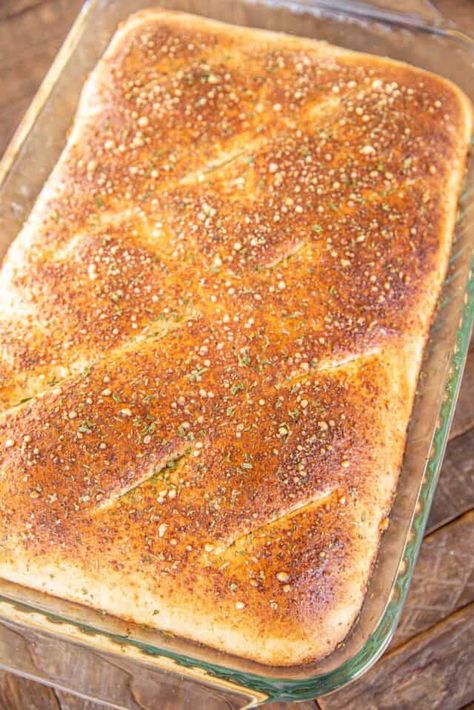 Family Style Calzone - this casserole is a favorite at our house. It is super simple to make and everyone loves it! Pizza dough stuffed with ricotta, mozzarella, parmesan, and your favorite pizza toppings and baked. Top the baked calzone with some warm spaghetti sauce and prepare to be wowed! Serve with a simple salad and you are set! Sheet Pan Calzone, Uses For Pizza Crust, Calzone Dough Recipe Easy, Calzone With Ricotta Cheese, Pizza Dough Calzone Recipe, Calzone Recipe With Ricotta Cheese, Spaghetti Calzone, Calzones With Pizza Dough Pillsbury, What To Make With Pizza Dough