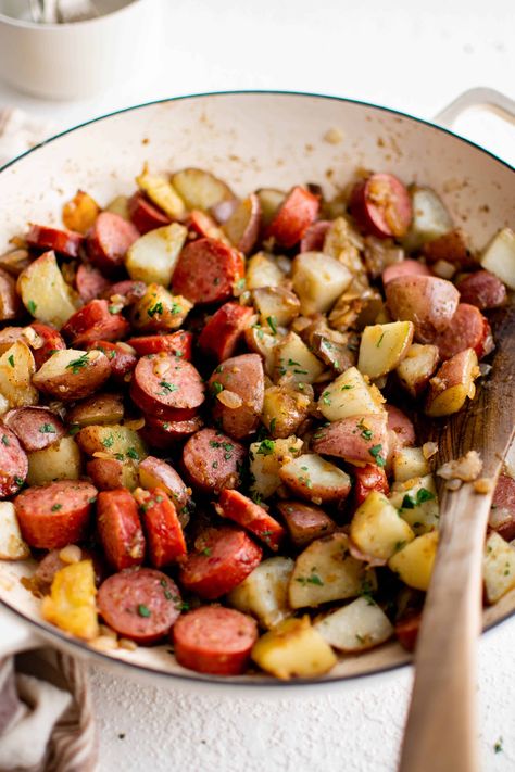 This quick and easy Kielbasa and Potatoes Recipe is the perfect one-dish weeknight dinner. Made with simple ingredients including red potatoes, onion, garlic, and flavorful kielbasa sausage, the whole family will love this flavorful combination. Smoked Sausage And Red Potatoes, Kielbasa And Potatoes Stovetop, Recipes With Beef Kielbasa, Fried Kielbasa, Turkey Kielbasa Recipes, Kilbasa Sausage Recipes, Easy Kielbasa Recipes, Kielbasa Sausage Recipes, Sausage And Potato Bake