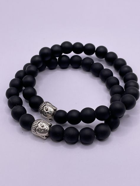 These beautiful Black Onyx Bracelets with silver plated Buddha head are handmade in Nepal. Strong elastic cord to fit most wrist sizes. Beautiful Natural Gemstone Bracelet with Buddha's head for Meditation or just for its beauty as fashion. Each bracelet has beautifully polished 8mm Gemstone beads and a very well-detailed silver-coloured Buddha head bead. It would make a lovely gift for your loved ones. Visit our Etsy shop for more: https://www.etsy.com/uk/shop/KathmanduCollections Male Bracelets, Buddha Bracelets, Wrist Mala, Mala Meditation, Buddha Beads, Bracelet Wrist, Black Onyx Bracelet, Beads Bracelet Design, Buddha Head