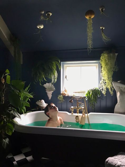 Urchin and air plant jellyfish over a rolltop bath in a dark, vintage bathroom and lots of bathroom plants. Farrow and Ball Stiffkey Blue. Blue Bathroom With Plants, Dark Plant Bathroom, Dark Blue Bathroom Aesthetic, Dark Bathroom With Plants, Jellyfish Bathroom Decor, Black Bathroom With Plants, Dark Jungle Bathroom, Dark Bathroom Plants, Dark Maximalist Bathroom