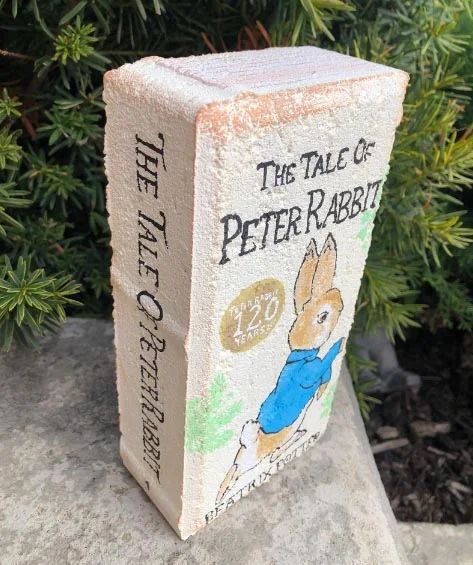 Garden Brick Books Diy, Garden Paver Books, Book Cover Painted Bricks, Diy Brick Books, Garden Bricks Painted Like Books, Brick Painted As Books, Book Painted Bricks, Painted Brick Books For Garden, Brick Books In Garden