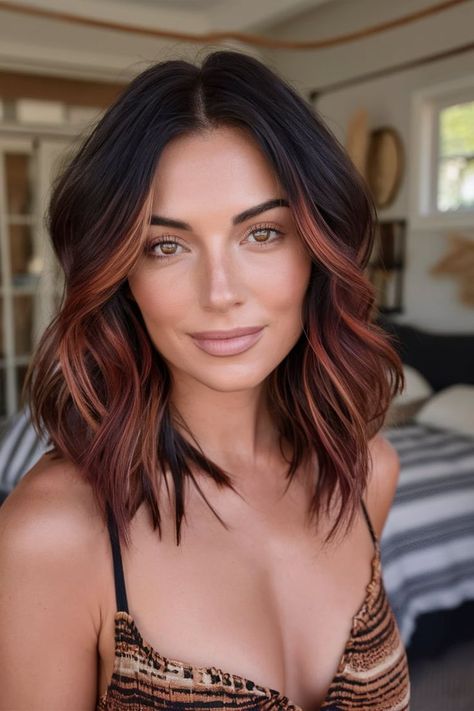 This fall haircut showcases a layered lob with rich copper balayage highlights, adding warmth and depth to your hair. The subtle waves enhance texture, making it perfect for those seeking a natural yet striking autumn look. Ideal for medium-length hair, this style offers a chic and effortless transition into the cooler months. Hair Color Ideas For Brunettes Red Ombre, Short Brunette Balayage Hair With Bangs, Tan With Dark Hair, Dark Copper Balayage Brunette Straight Hair, Balayage Hair Medium Brown, Two Tone Bob Hairstyles, Chocolate And Caramel Balayage, Fall Mid Length Hair Colors, Short Black Hair With Copper Highlights