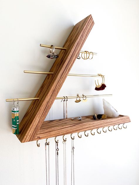 This wall mounted floating jewelry organizer is made with solid exotic zebrawood, brass rods and brass hooks. This is a modern piece with an open triangle concept. It is dowel joined with no nails or screws, keeping the aesthetics of this piece, our number one priority. There are absolutely no stains applied to our wood. We let the natural brilliance radiate with Sam Maloof poly/oil and oil/wax wood finishes. This organizer is a great platform to showcase your favorite jewelry pieces as well as Floating Jewelry, Jewlery Holder, Sam Maloof, Wood Jewelry Diy, Brass Rods, Wood Jewelery, Wall Mount Jewelry Organizer, Jewelry Organizer Wall, Jewelry Wall