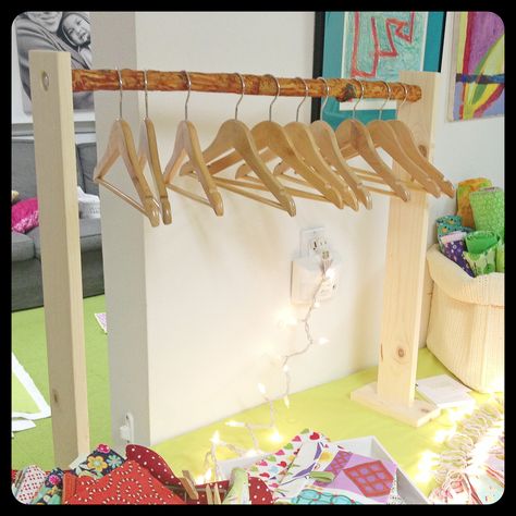 Easy branch rack for our craft show booth setup (table top). This is a mini one that holds small children's hangers, click on for a picture of the larger one. Market Stall Hanging Display, Diy Clothes Rack For Craft Show, Display For Hanging Items, Craft Fair T Shirt Display, Onesie Display Craft Fairs, Table Runner Display Craft Show, Tabletop Hanging Display, Craft Fair Hanging Display, Display Hanging Items Craft Booths