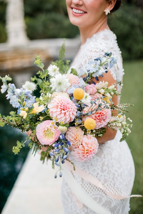 Planning a spring of summer wedding with a subtle pop of color, use this pastel bridle  bouquet as inspiration. The light pink, blue, and yellows make for the perfect spring or summer bouquet. | John Myers Photography & Videography Pink Blue Yellow Wedding Flowers, Pink And Blue Wildflower Bouquet, Blue Green And Pink Wedding, Blue Yellow Pink Wedding, Blue And Yellow Bouquet, Yellow Wedding Colors Schemes, Pink Yellow Weddings, Cheekwood Wedding, Blue Yellow Weddings