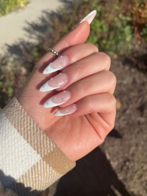 fake nails with french design and pearls Heart And Pearl Nails, White Tip With Pearl Nails, French And Pearl Nails, Fancy French Acrylic Nails, Almond Nails With Pearl Gems, French Nails With Gemstones, French Nails Asthetics, French Nail With Pearl, Almond French With Pearls