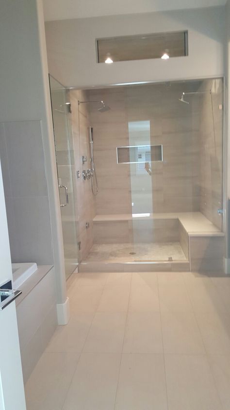 Spacious master steam shower with double rain heads Extravagant Showers Master Bath, Best Showers For Two, Shower With Cathedral Ceiling, Steam Shower With Bench, Double Rain Shower Master Bath, Shower With Steam Room, Steam Shower Bench, Double Shower With Bench, Steam Bathroom Ideas