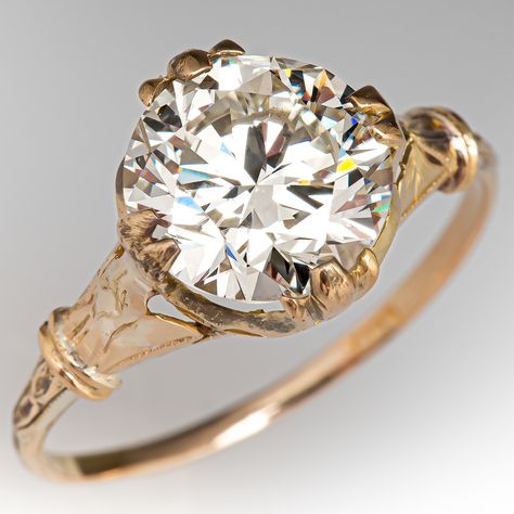 This fantastic vintage diamond engagement ring features engraved details and contains one (1) round brilliant cut diamond weighing 2.03 carats that is set into a four-split prong setting. The ring measures 9.5mm at the top, rises 6.0mm above the finger, tapering to 1.2mm wide and 0.8mm thick at the base of the shank. The ring is currently a size 5.5. 5 Carat Round Diamond Ring, Vintage Round Engagement Ring, Cushion Cut Vintage Engagement Ring, Georgian Engagement Ring, 1950s Engagement Ring, Vintage Diamond Necklace, Vintage Diamond Engagement Ring, Stacked Rings, Cushion Cut Diamond Ring