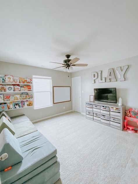 Square Playroom Layout, Dining Room Transformed Into Playroom, Large Living Room Layout With Play Area, Transitional Playroom Ideas, Toy Room With Couch, Long Narrow Playroom Layout, Playroom Above Garage, Brother Sister Playroom Ideas, Playroom With Sectional