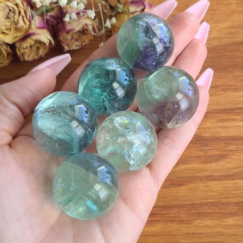 "*Please use the drop down menu to choose your preferred fluorite sphere size. Most of these are a clear green color, but please message us if you have any requests!* **Each sphere will come with a small stand** Approximate Dimensions: Tiny = 25-30 mm, (around 1\") 28-50 grams X-Small = 31-35 mm, (around 1.25\") 50-75 grams Small = 36-40 mm (around 1.5\") 78-115 grams Medium = 41-45 mm (around 1.75\") 115-158 grams Large = 46-50 mm, (around 2\") 159-213 grams 1 inch = 25.4 mm 1 pound = 453.6 gra Crystal Core Aesthetic, Rainbow Feather, Crystal Vibes, Crystal Aesthetic, Purple Feather, Crystal Grids, Pretty Rocks, Cool Rocks, Les Chakras