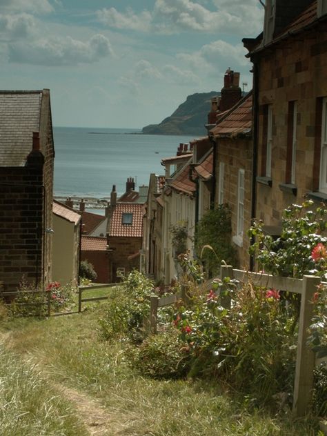 Robin Hood's Bay, Yorkshire, England, this magical seaside village clings precariously to a steep cliff sloping down to the North Sea. It is incredibly pretty and reminiscent of years gone by, when smugglers used to ferry their cargo along its winding streets. Whitby England, Robin Hoods, Yorkshire Coast, Robin Hoods Bay, Northern England, Seaside Village, Seaside Town, British Countryside, Yorkshire Dales