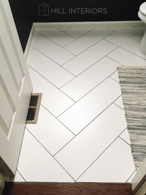 Powder Room Herringbone Floor, White Chevron Floor Tile, White Floor Black Grout, Laundry Room White Tile Floor, White Tile Herringbone Floor, White Herringbone Tile Black Grout, White Tile Floor Dark Grout, White Tile With Black Grout Floor, White Tile Dark Grout Kitchen Floor