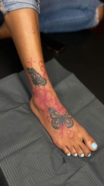 Butterfly Anklet Tattoo, Elephant Ankle Tattoos For Women, Foot Tattoos Black Women, Baddie Foot Tattoos, Foot Tattoos For Women Black Woman, Foot Tattoos For Black Women, Pink Ink Tattoo On Dark Skin, Rose Foot Tattoos For Women, Red Foot Tattoos