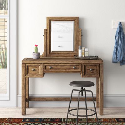 This rustic vanity and mirror is the ideal spot to apply makeup, store away items, and add style to your main bedroom or guest room. It's crafted from a mix of solid and engineered wood in a toffee brown finish, and showcases aged cracks and distressing in the wood to give it an authentic look. Each drawer front is framed with antique nickel-finished drawer pulls for a touch of accent. Tuck away jewelry, hairbrushes, and makeup in the vanity's three drawers, which feature removable felt-lined je Rustic Makeup Vanity Ideas, Western Vanity, Rustic Makeup Vanity, Hacienda Decor, Wood Makeup Vanity, Weathered Wood Finish, Vanity With Mirror, Vanity Bedroom, Farmhouse Vanity