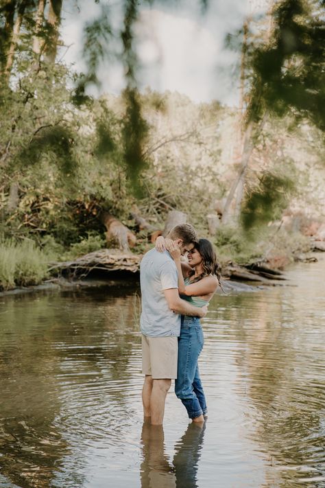 couple standing in lake for engagement photos Couples Water Photoshoot Ideas, Couples Photo Shoot In Water, Engagement Photo Water, Couples Creek Photos, Fall Water Engagement Pictures, Engagement Pictures By Water, Water Pictures Photography Couples, Couples Photoshoot By Water, Couples Photoshoot In Creek