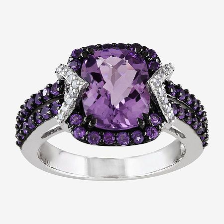 This genuine amethyst and diamond ring adds elegance to all your dressing decisions.Metal: Sterling silverStone: 10x8mm cushion-cut genuine amethystOther Stones: 1/10 ct. t.w. diamondsSetting: ProngDimensions: 23.1x13mm highCare: Wipe CleanCountry of Origin: ImportedGemstones may be treated and may require special care.Diamond total weights may vary between .01 and .08 carat.Jewelry photos are enlarged to show detail. Disclaimer: Metal may be rhodium plated to enhance appearance and reduce tarn… Sterling Silver Halo Ring, Silver Halo Ring, Amethyst And Diamond Ring, Purple Jewelry, Amethyst Jewelry, Purple Stones, Art Deco Ring, Diamond Fashion, Halo Ring