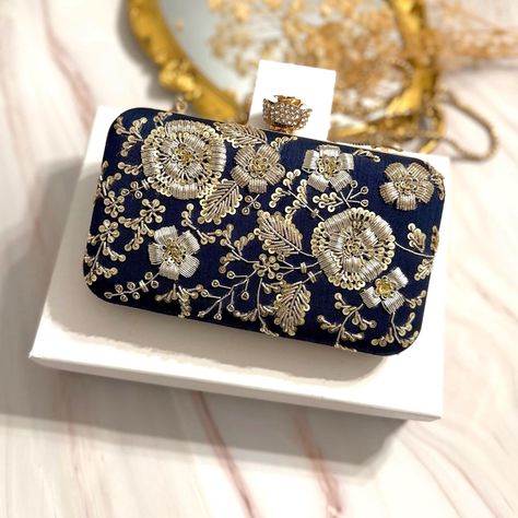 Midnight Blue Clutch, Dark Blue Clucth, Navy Blue Clucth, Evening Bag, Gift for Bride, Gift for Mom Introducing our Midnight Blue Bridal Clutch with Hand-Embroidered Dual Tone Zardozi Work--a perfect blend of opulence and craftsmanship. Immerse yourself in the luxury of premium quality as we present a meticulously designed accessory that stands out from the rest. Crafted with a premium quality frame and adorned with hand-embroidered Zardozi work, this clutch is a testament to the artistry and attention to detail that sets it apart. Beautiful raw silk adds a touch of sophistication, ensuring you carry an accessory that exudes elegance. Open the clutch to reveal a sumptuous suede fabric lining, providing a soft and luxurious interior. We've considered your practical needs with a small pocket