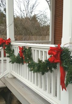 Christmas Porch Decor Garland, Porch Banister Christmas Decor, Porch Railing Christmas Decorations, Attach Christmas Lights To House, Garland On Outdoor Railing, Christmas Front Porch Garland, Outdoor Christmas Garland Porch, Christmas Porch Garland Ideas, Outside Garland Christmas Porch Ideas