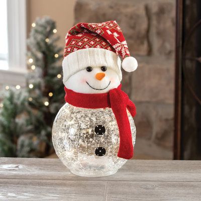 Brighten your holiday with this plush and crackle glass snowman. Includes 10 starry lights. Studio 66 | Studio 66 Frosty Top Lighting 7.2 H x 7.2 W x 9.96 D in brown / red / whiteGlass / Mercury Glass | 7.2" H X 7.2" W X 9.96" D | Wayfair Vase Snowman, Allergy Medicine, Starry Lights, Glass Snowman, Snowman Christmas Decorations, Christmas Glasses, Blue Christmas Tree, Boutique Items, Snowman Decorations