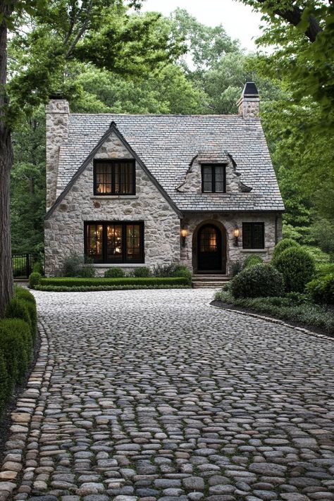 Modern English cottage front yard with cobblestone driveway lined with trees. Check out all of these modern English cottages that are as charming as they are functional. Can this be your dream home? Brick English Cottage Exterior, English Home Plans, Quaint Cottage Exterior, English Cottage Layout Floor Plans, Modern Stone Cottage Exterior, English Cottage Home Exterior, English Country Exterior Homes, Small Stone Cottage House Plans, English Cottage House Plans One Story