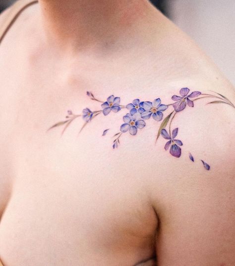 21 Alluring Violet Flower Tattoos For A Delicate Expression Violate Flower Tattoo, Violet Shoulder Tattoo, Violet Collarbone Tattoo, Wild Violets Tattoo, Violet Vine Tattoo, Violet Flower Tattoo Color, Violet Flower Tattoo Designs, Colorful Flower Tattoo Designs, Clematis Tattoo