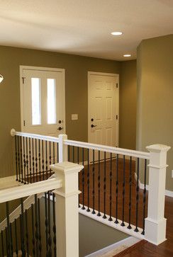 Stair Systems | white staircase with black wrought iron balusters | Bayer Built Woodworks Banister Makeover, White Banister, Banister Remodel, Stair Railing Makeover, Iron Stairs, Wrought Iron Stair Railing, White Staircase, Open Stairs, Iron Stair Railing