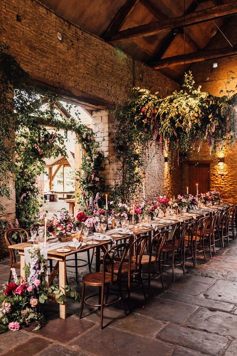 One long banquet table for an intimate wedding decorated with pink and purple flowers and candles for cosy romantic wedding Extravagant Wedding Decor, Botanical Wedding Theme, Long Table Wedding, Wedding Sign Decor, Colorful Wedding Flowers, Wedding Venues Uk, Spring Wedding Flowers, Rock My Wedding, Wedding Breakfast