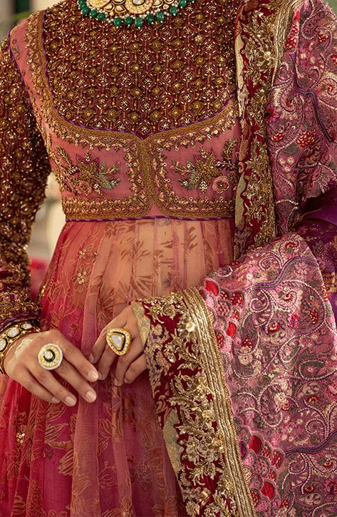 Pakistani Bridal Dress in Pishwas Frock Sharara Style is an iconic attire that has the perfect balance of traditional and glamorous look. Hand-crafted embellishments and luxury designs make this beautiful Pishwas Dress an epitome of beauty and your foremost priority. Pakistani Bridal Pishwas: Pakistani Bridal Pishwas Frock in an alluring pink shade is adorned with hand-crafted details of shimmering sequins, and motifs. Lavish floral designs and fine details of embroidery make this Pakistani Pish Gorgeous Pakistani Dresses, Pink Bridal Pakistani, Pakistani Suits Bridal, Bridal Sharara Pakistani, Pishwas Designs, Frock Sharara, Traditional Pakistani Dresses, Angharka Style Frock, Bridal Sharara Designs