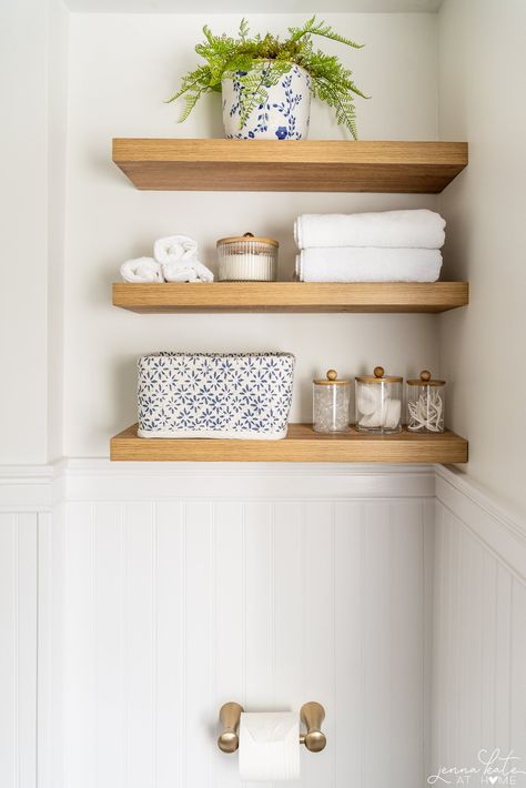 Beachy Bathroom Shelves, Toilet Room Floating Shelves, Natural Wood Floating Shelves Bathroom, Simple Room Renovation Ideas, Shelf In Bathroom Above Toilet, Small Bathroom Floating Shelves, Floating Shelf Bathroom Decor, Floating Wood Shelves Bathroom, Wood Shelves Above Toilet