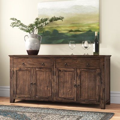 This sideboard adds essential storage to your dining room while creating a rustic-inspired accent. It's made from solid and engineered wood in a brown finish with visible wood grain for an antique, farmhouse design right out of the box. Frame and crown molding create a traditional silhouette. Two double-door cabinets open to reveal shelves that help to organize your spare serve ware or barware. Plus, two wide drawers offer additional out-of-sight storage. Ring pulls on doors and drawers add to t Tv Buffet Tv Consoles, Sideboard Buffet In Dining Room, Talkin Tennessee, Rustic Buffet Cabinet, Dark Wood Sideboard, Living Room Credenza, Dining Room Credenza, Dining Room Buffet Table, Tall Sideboard