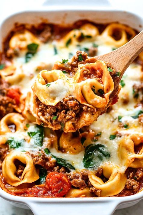 This easy baked tortellini is hearty and comforting! With layers of tortellini, meat sauce, spinach, and cheese, it’s sure to become a favorite. Tortellini Bake Crockpot, Tomato Tortellini Recipes, Spinach Cheese Tortellini Recipes, Tortellini With Spaghetti Sauce, Garlic Parmesan Beef Tortellini Bake, Low Carb Tortellini, Tortellini Ground Beef Recipes, Ground Beef Tortellini Recipes, Beef And Tortellini Recipes