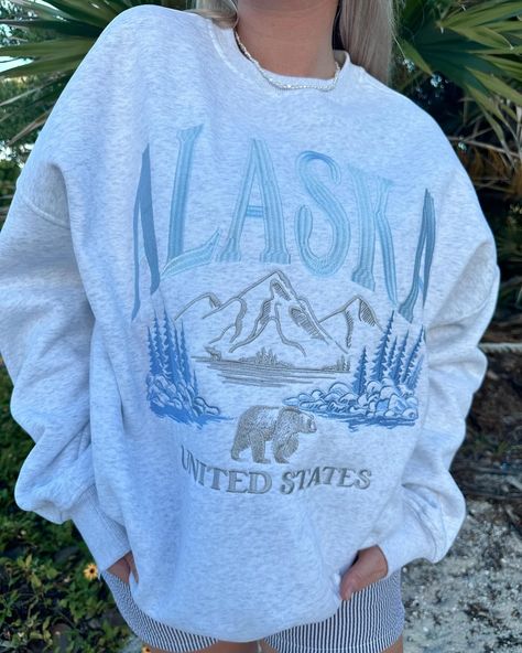 Our new Alaska graphic sweatshirts are going quick! Swipe to see it on! 🐻🌲🏔️ // $69.50 Cute Sweatshirts, Clothing Logo, Logo Collection, Pearl Grey, Embroidered Sweatshirts, Sweater Accessories, Christmas Shopping, Unisex Fashion, Tank Shirt