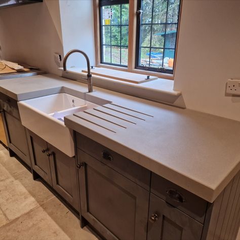 Looking for a stylish and long-lasting countertop solution for your kitchen? Our custom-made concrete countertops are not only visually stunning but also built to last. See our latest project featuring these beautiful countertops in a stunning single-family home. With easy maintenance and a sleek modern design, our concrete countertops are the perfect upgrade for any kitchen.

#concretecountertops #kitchendesign #homedecor #interiordesign #kitchenremodel #concretedesign #modernkitchen Small Kitchen Concrete Countertops, Concrete Shelves Kitchen, Polished Concrete Kitchen Countertops, Tan Concrete Countertops, Concrete Worktop Kitchen, Cement Countertops Kitchen, Kitchens With Concrete Countertops, Beautiful Countertops, Polished Concrete Countertops