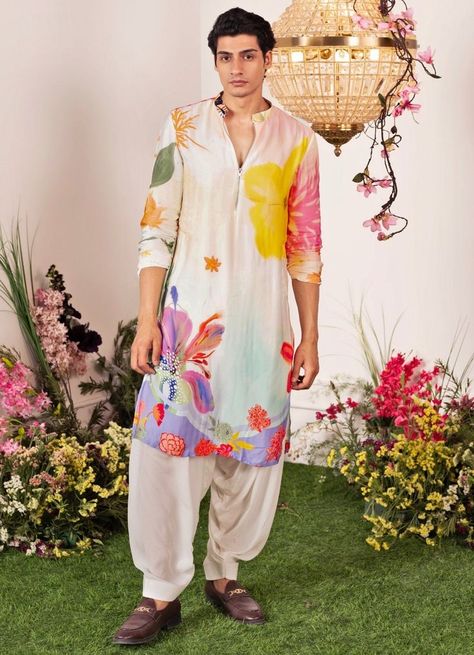 Check out these stunning and fresh tropical-themed outfits for grooms, from pastel bandhgalas to unique floral kurtas. Perfect for your exotic wedding! Hand Printed Kurta For Men, Mens Mehendi Outfits, Men Mehendi Outfits, Haldi Kurta For Groom, Haldi Outfits For Groom, Mehendi Outfits For Men, Men Printed Kurta, Floral Kurta For Men, Haldi Kurta